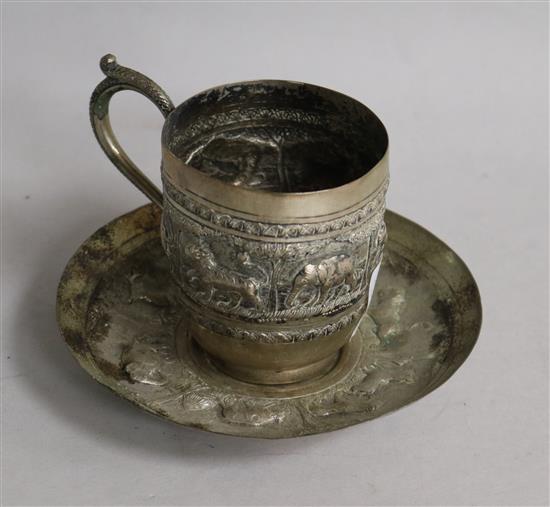 An Indian white metal tea cup and saucer.